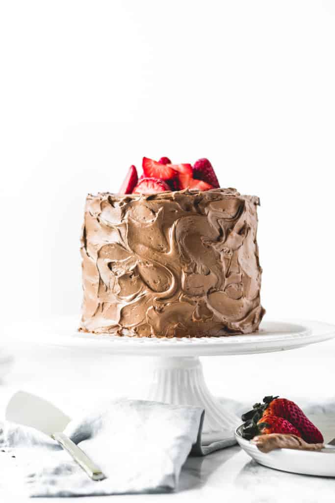 Three layers of rich and soft chocolate cake, paired with light and airy chocolate buttercream and filled with luscious dark chocolate ganache.  It doesn't get more chocolatey than this!⎪www.anasbakingchronicles.com