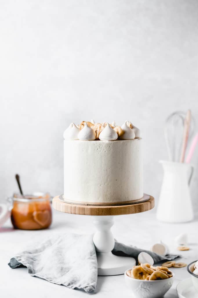 This Dulce de leche Banana Cake is a dream come true! Rich and moist banana cake layers are filled with luscious dulce de leche and coated in the most beautiful vanilla bean frosting! Perfect for Mother's Day! ⎪www.anasbakingchronicles.com