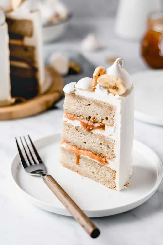 This Dulce de leche Banana Cake is a dream come true! Rich and moist banana cake layers are filled with luscious dulce de leche and coated in the most beautiful vanilla bean frosting! Perfect for Mother's Day! ⎪www.anasbakingchronicles.com