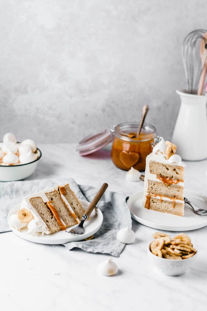 This Dulce de leche Banana Cake is a dream come true! Rich and moist banana cake layers are filled with luscious dulce de leche and coated in the most beautiful vanilla bean frosting! Perfect for Mother's Day! ⎪www.anasbakingchronicles.com