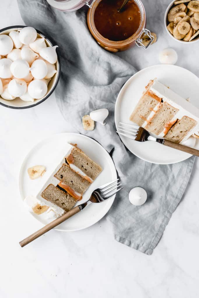 This Dulce de leche Banana Cake is a dream come true! Rich and moist banana cake layers are filled with luscious dulce de leche and coated in the most beautiful vanilla bean frosting! Perfect for Mother's Day! ⎪www.anasbakingchronicles.com