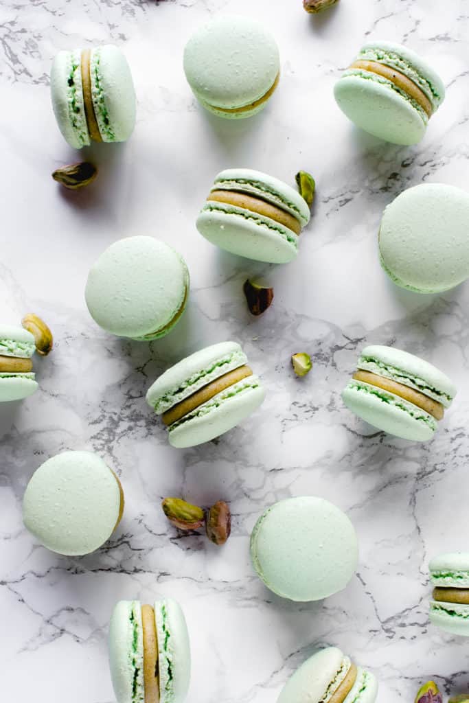 Sweet and chewy macarons, the most decadent of French desserts, filled with rich Pistachio White Chocolate ganache. It's a match made in heaven!⎪www.anasbakingchronicles.com