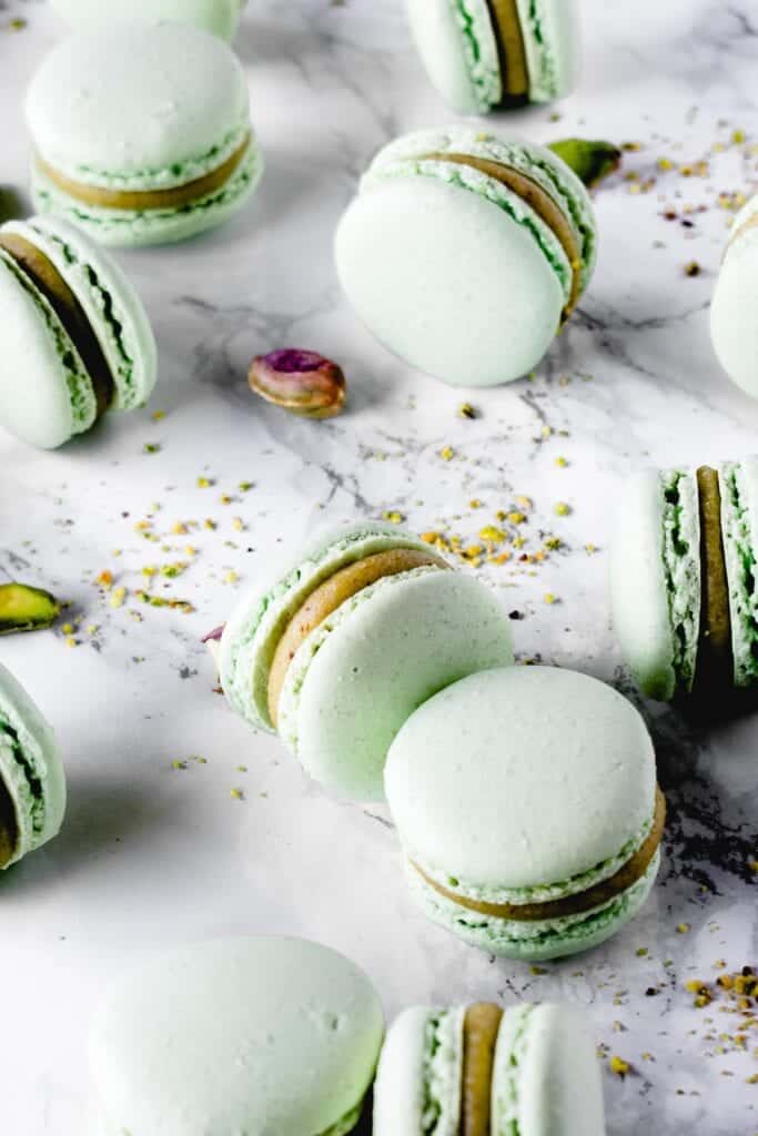 Sweet and chewy macarons, the most decadent of French desserts, filled with rich Pistachio White Chocolate ganache. It's a match made in heaven!⎪www.anasbakingchronicles.com