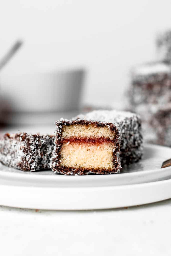 These Lamingtons are the perfect combination of soft and moist vanilla cake, strawberry jam and luscious chocolate icing with coconut coating. Perfect for the holidays or a Sunday afternoon! ⎪www.anasbakingchronicles.com