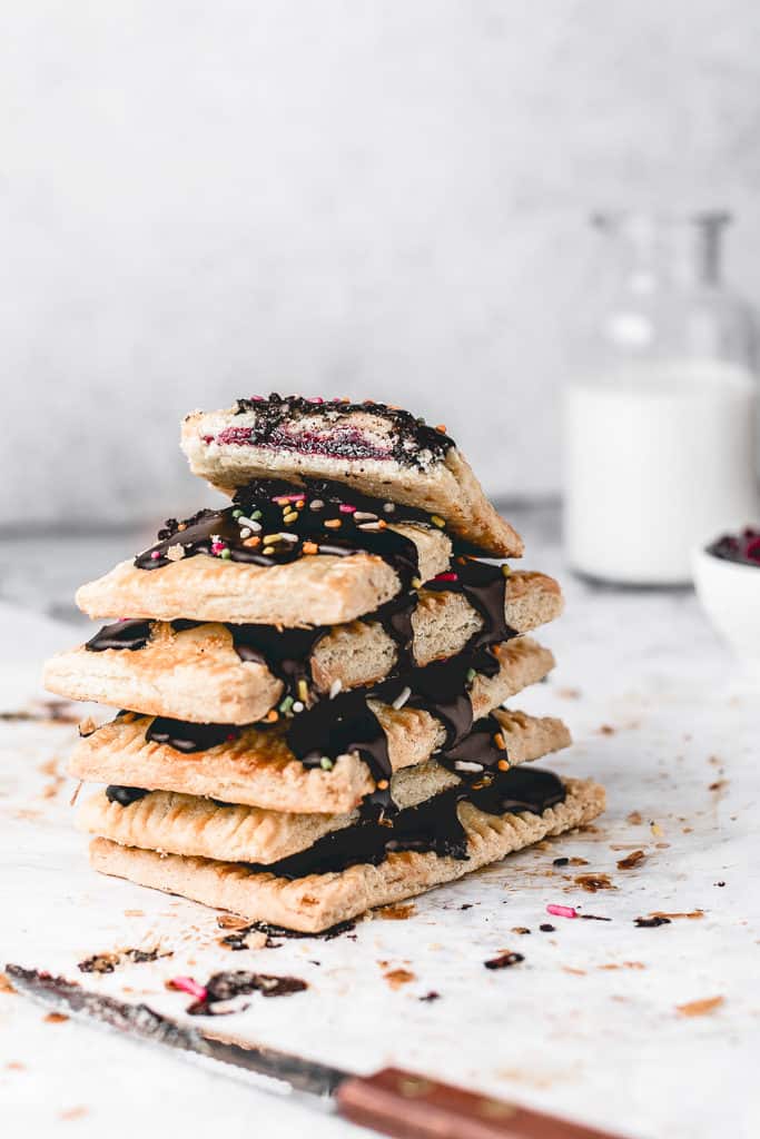 These Cherry Pop Tarts with sprinkled Chocolate glaze are a perfect snack. Sweet and tangy cherry filling, cloaked in flaky, all-butter pie crust and then topped with simple chocolate glaze - heavenly combination! Ooh, let's not forget sprinkles! ⎪www.anasbakingchronicles.com