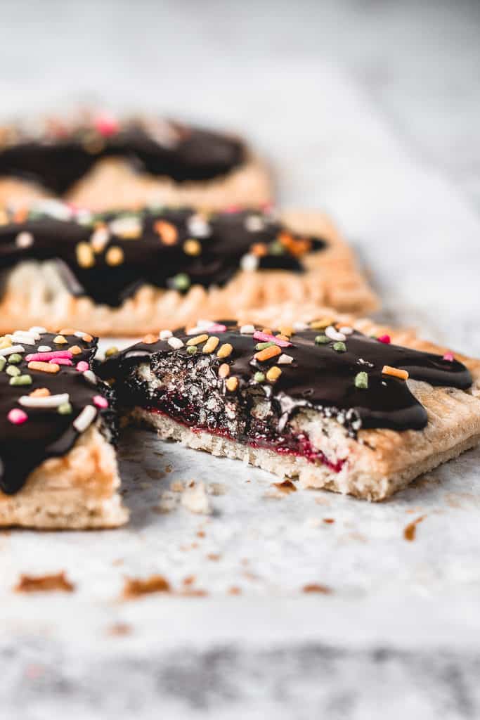 These Cherry Pop Tarts with sprinkled Chocolate glaze are a perfect snack. Sweet and tangy cherry filling, cloaked in flaky, all-butter pie crust and then topped with simple chocolate glaze - heavenly combination! Ooh, let's not forget sprinkles! ⎪www.anasbakingchronicles.com