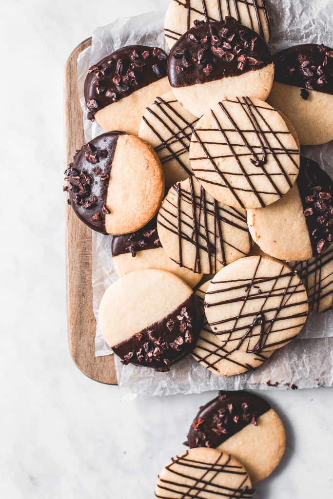 These buttery, melt-in-your-mouth orange shortbread cookies are dipped in chocolate and incredibly easy to make - a classic with a twist!⎪www.anasbakingchronicles.com