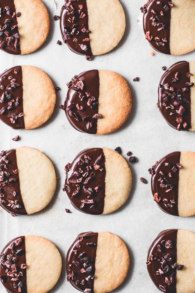 These buttery, melt-in-your-mouth orange shortbread cookies are dipped in chocolate and incredibly easy to make - a classic with a twist!⎪www.anasbakingchronicles.com