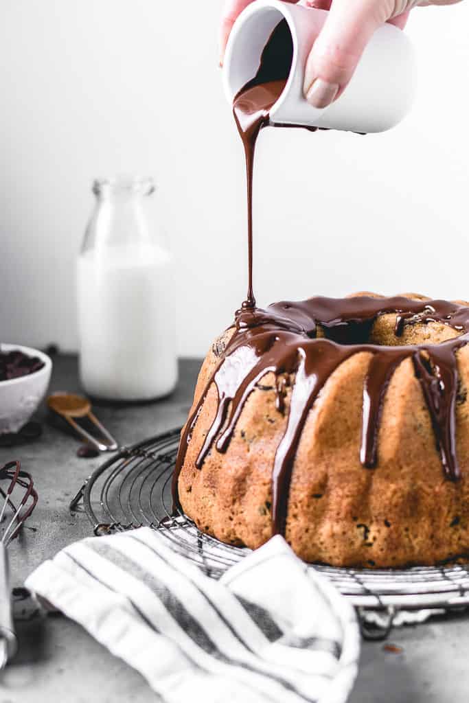 This Chocolate Chip Pumpkin Bundt Cake is a perfect fall treat! Incredibly moist and delicious pumpkin spice cake with chocolate chips and covered in decadent chocolate glaze.⎪www.anasbakingchronicles.com