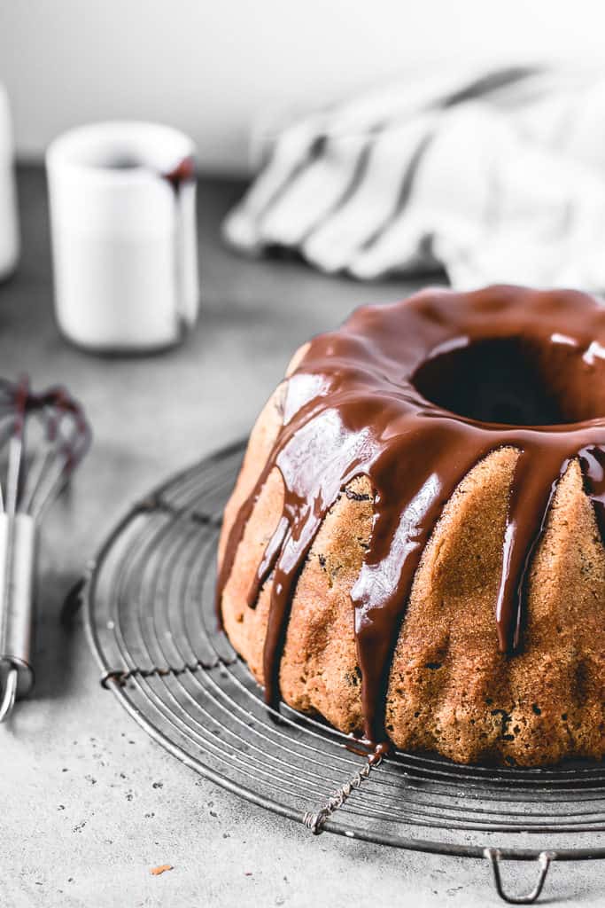 This Chocolate Chip Pumpkin Bundt Cake is a perfect fall treat! Incredibly moist and delicious pumpkin spice cake with chocolate chips and covered in decadent chocolate glaze.⎪www.anasbakingchronicles.com