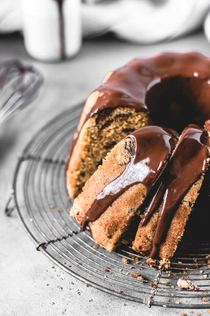 This Chocolate Chip Pumpkin Bundt Cake is a perfect fall treat! Incredibly moist and delicious pumpkin spice cake with chocolate chips and covered in decadent chocolate glaze.⎪www.anasbakingchronicles.com