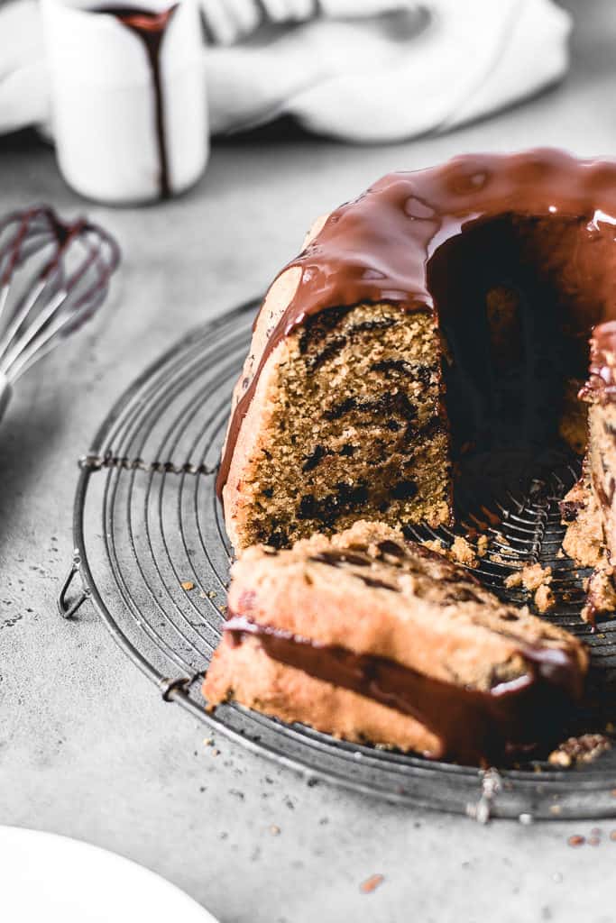 This Chocolate Chip Pumpkin Bundt Cake is a perfect fall treat! Incredibly moist and delicious pumpkin spice cake with chocolate chips and covered in decadent chocolate glaze.⎪www.anasbakingchronicles.com