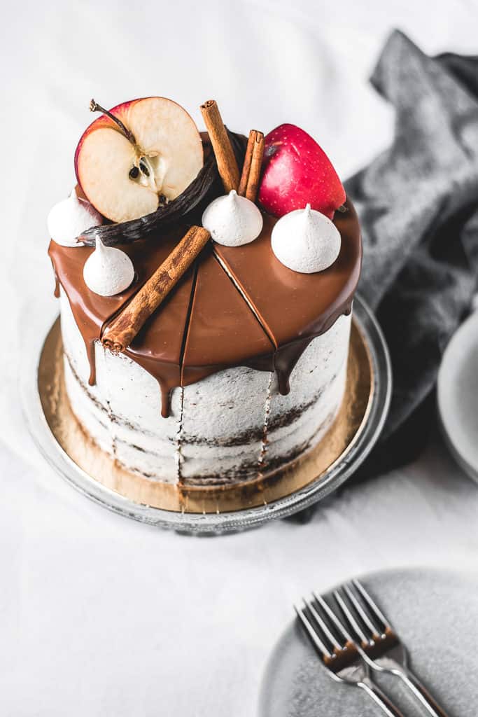 Fluffy and moist carob apple cake, filled with delicious chocolate ganache and coated in light rum buttercream frosting. Perfect fall combination! | www.anasbakingchronicles.com