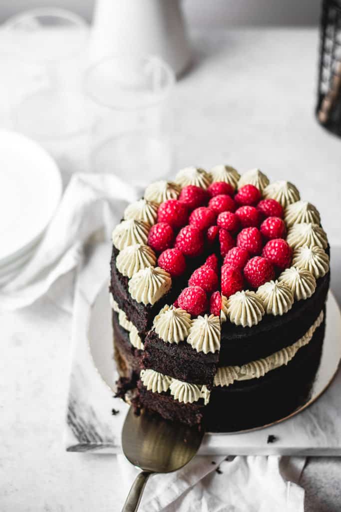 Rich and moist chocolate cake, paired with silky pistachio buttercream and homemade raspberry jam. So festive and easy to make! ⎪www.anasbakingchronicles.com