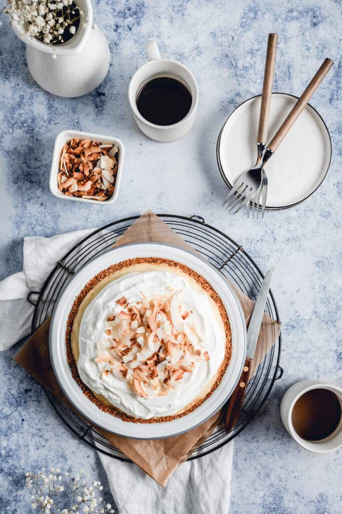 Freshly made coconut cream pie, placed on a wire rack and served