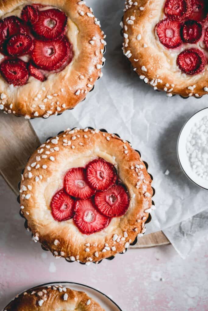 Brioche tarts made with tonka bean pastry cream and strawberries - closeup image.