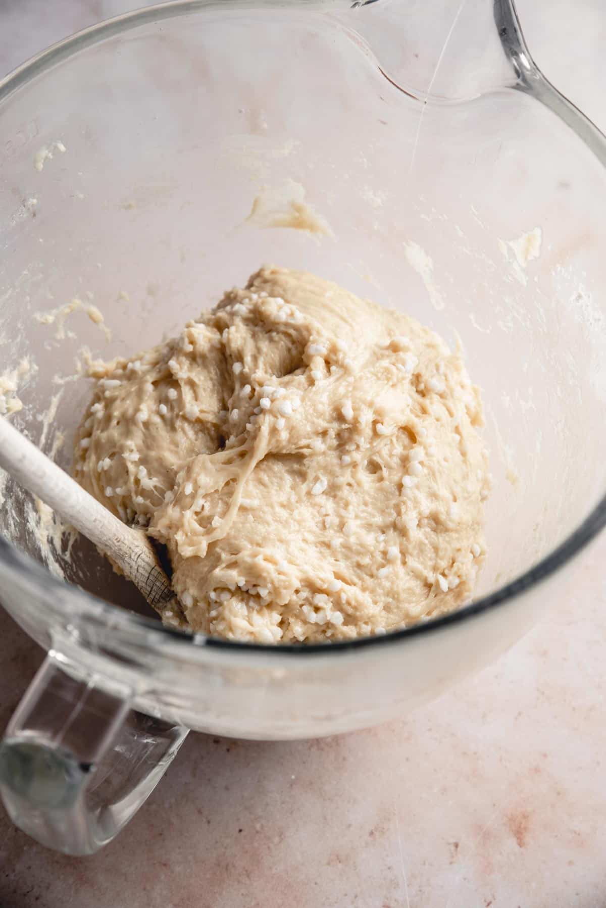 The finished belgian liege waffle dough, mixed with pearl sugar, in a bowl.