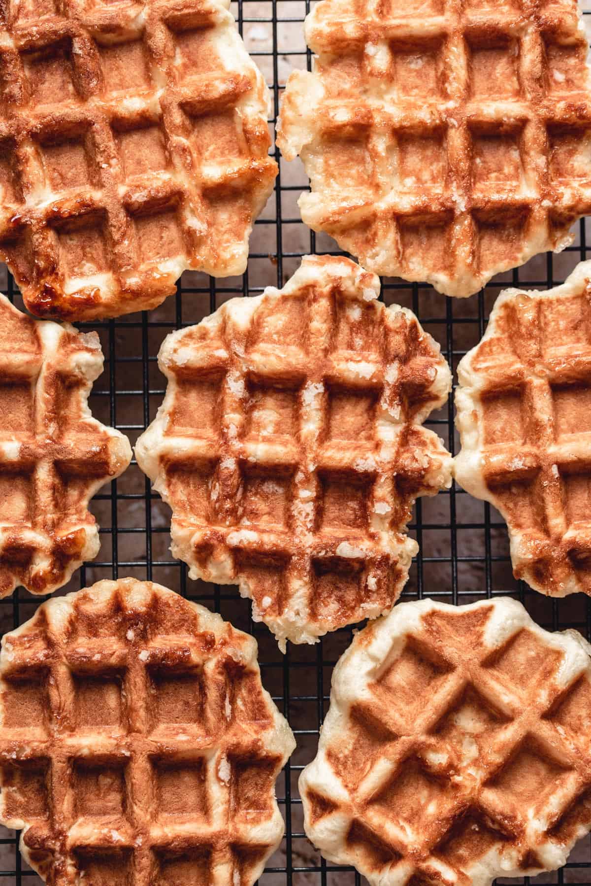 Close-up of cooked waffles on a cooling rack.