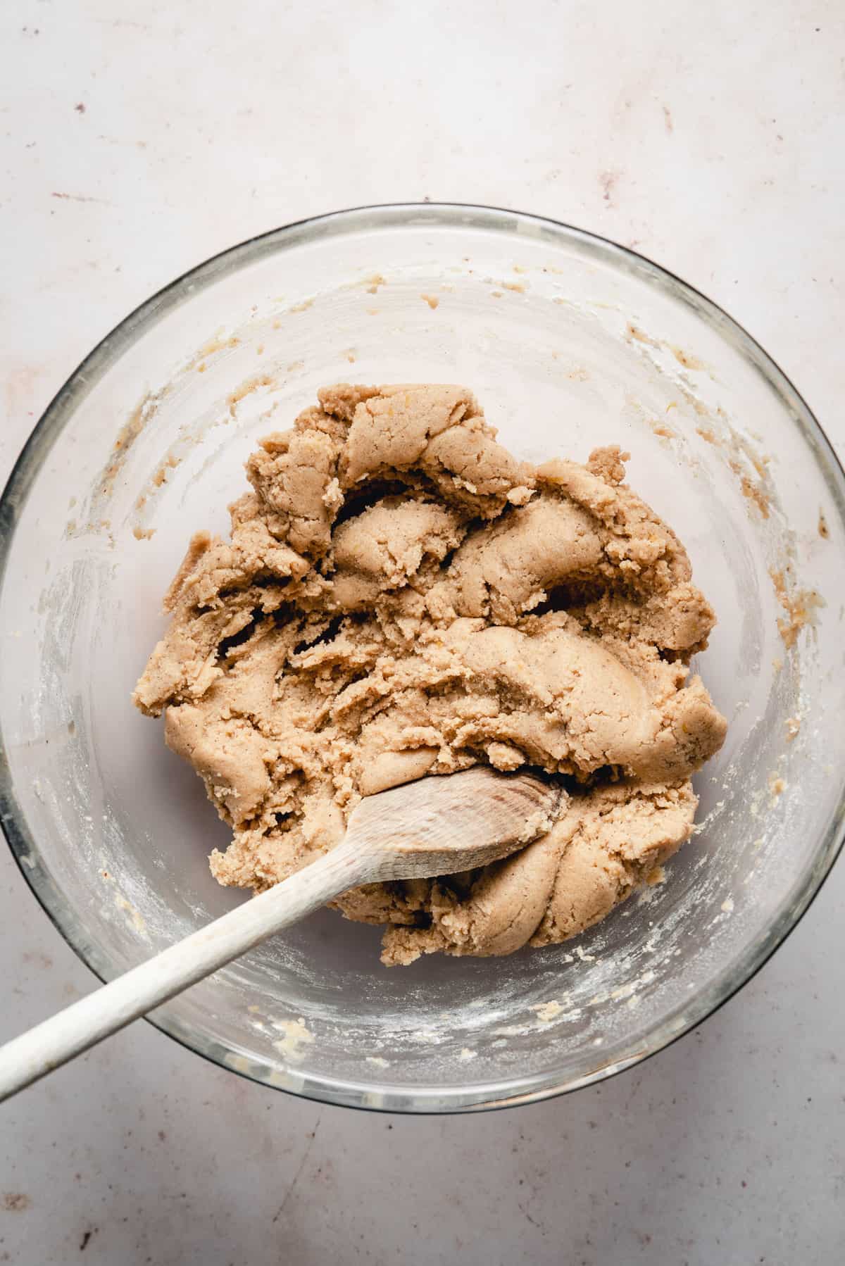 Cookie dough in a bowl before adding chocolate and raspberries