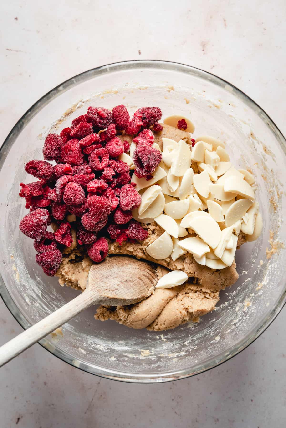 Bowl with cookie dough and chocolate and raspberries waiting to be mixed in