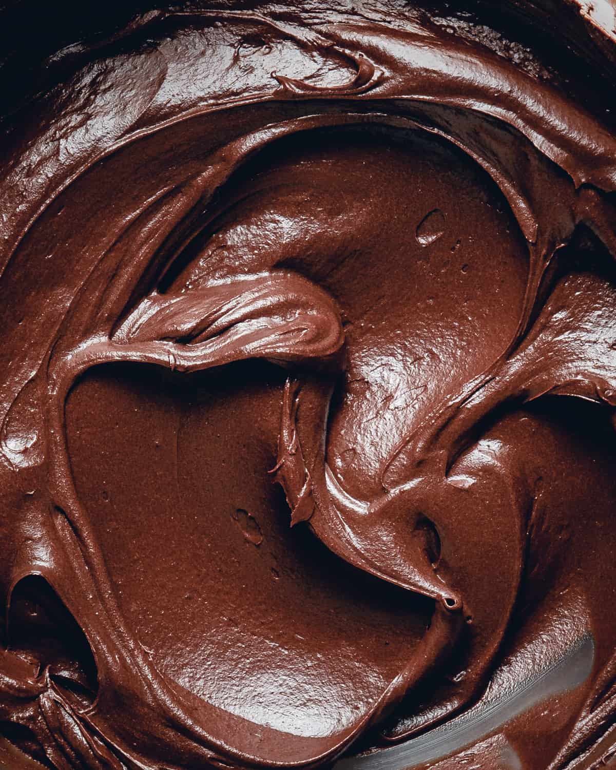 Silky chocolate doughnut filling close-up picture.