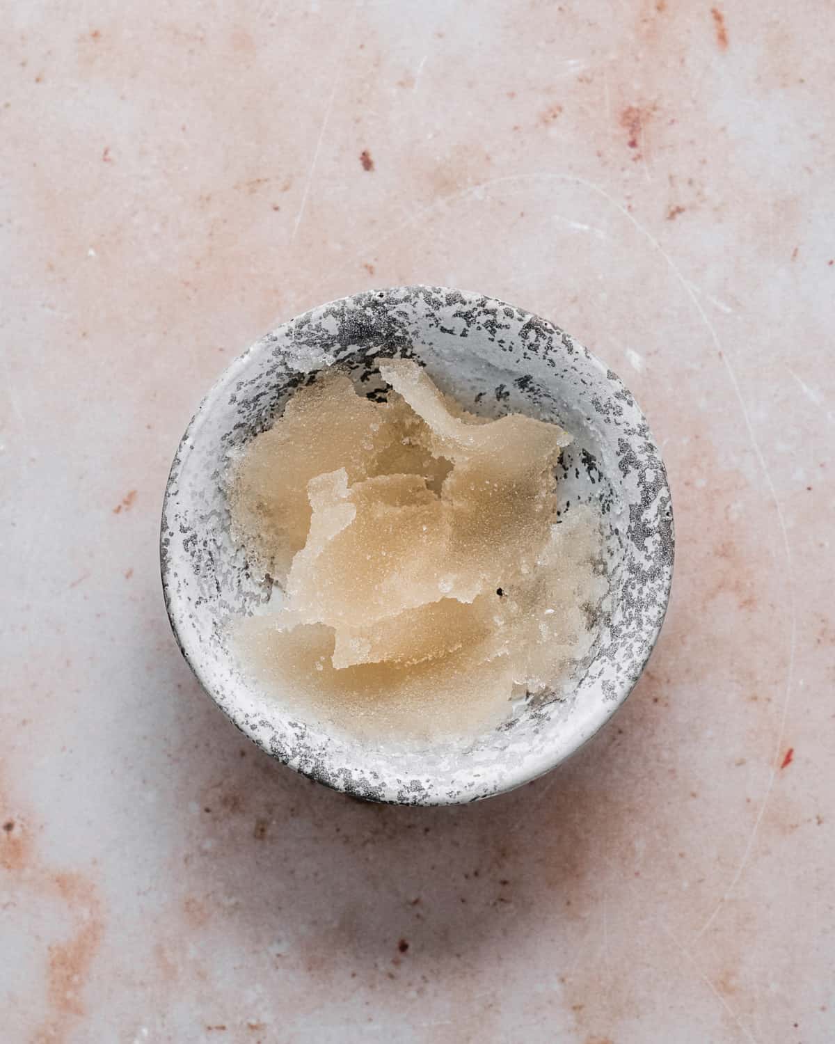 Bloomed gelatine powder in a small bowl.