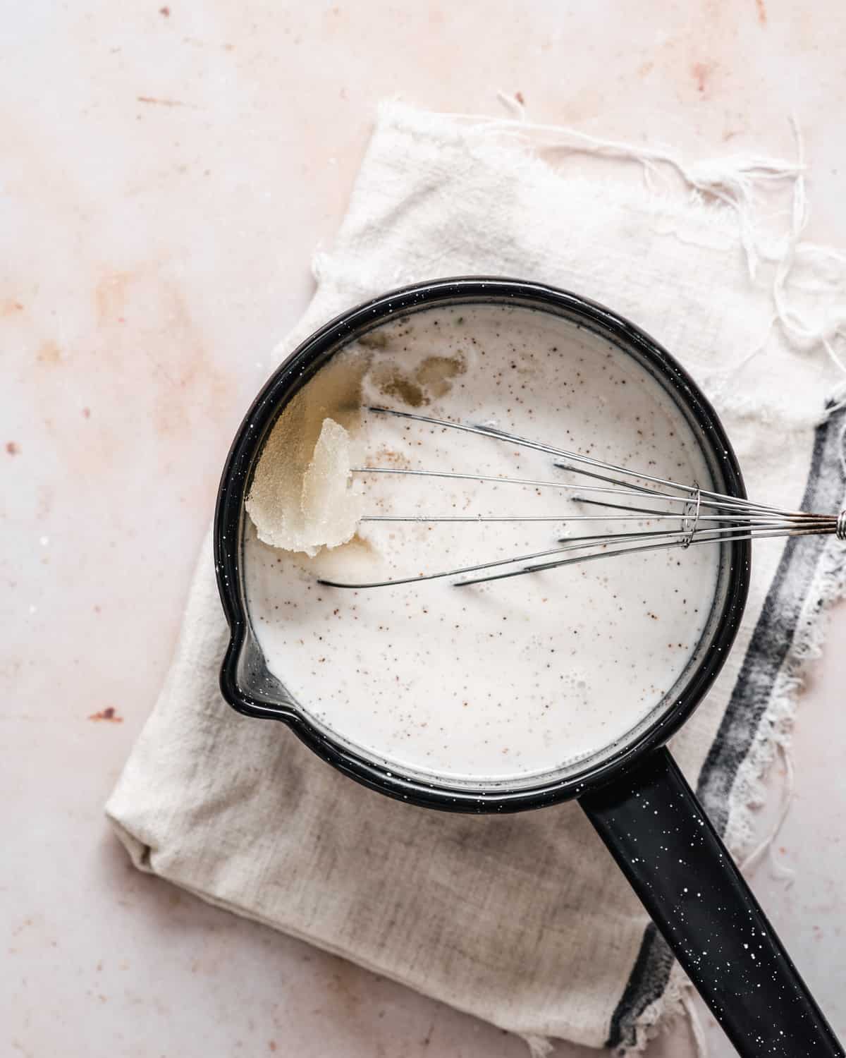 Mixing the bloomed gelatine with a hot coconut milk mixture.