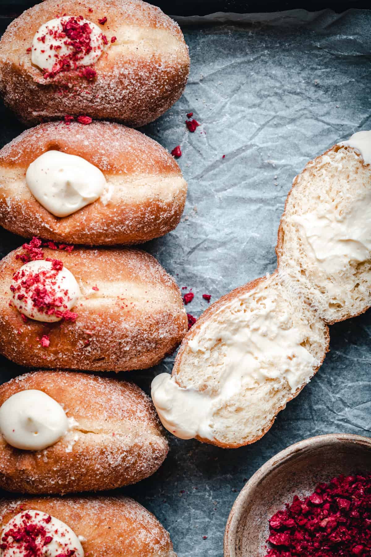 Doughnuts filled with creme diplomate cut in half to show the filling